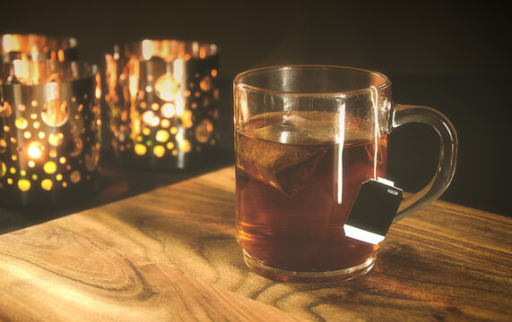 A cup of tea with tea light holders in the background. 