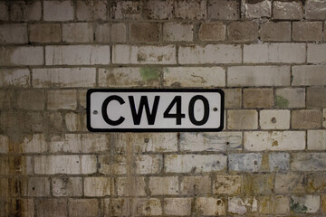 CW40 sign on dirty textured wall