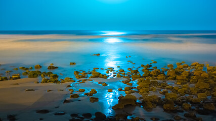 Beautiful seascape with a reflection of moon lights by night in Imesouane Morocco