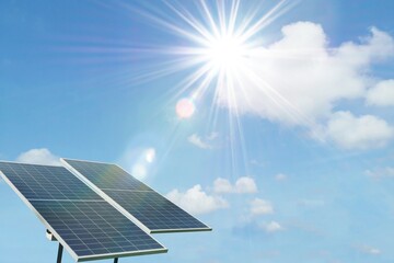 Polycrystalline silicon solar cells panels isolated on blue sky with sun light effect background....