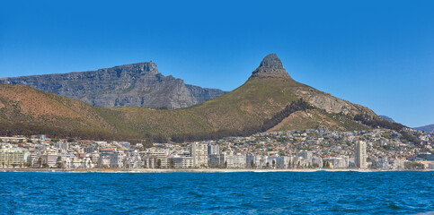 Panorama seascape with clear blue sky copy space and modern hotel apartment buildings in the background. Sea Point with a view of Lions Head and Table Mountain National Park, Cape Town, South Africa