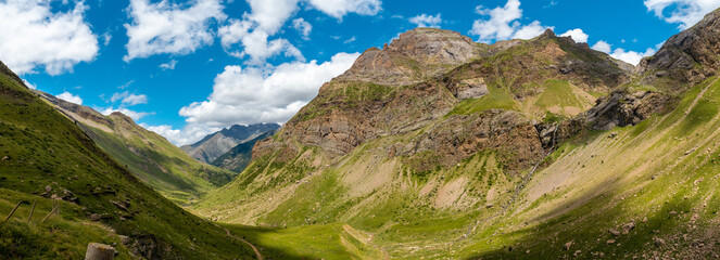 Fototapeta na wymiar Panoramic view from the corner of the green and the Salto de Tendenera Waterfall in the Ripera Valley, Pyrenees