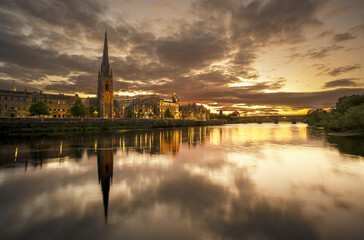 Fototapeta na wymiar Beautiful sunset at St Matthew's Church on River Tay with reflection , Perth , Scotland
