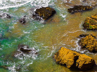 Clean water and brown rocks
