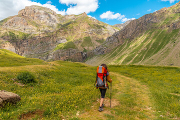 A young woman on mountain trekking with her son in the Ripera valley, Pyrenees mountains