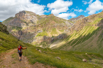 A young woman on the trail in the mountain trekking with her son in the Ripera valley, Pyrenees