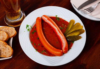 Traditional austrian food, boiled vienna sausages with goulash sauce in a restaurant