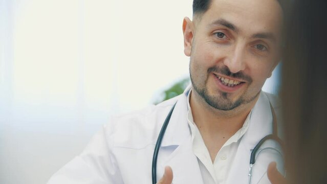 4k slow motion video of doctor wearing white lab coat holding explaining.