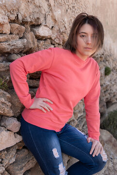 Teenager girl wearing pink long sleeve shirt standing outdoor, mockup