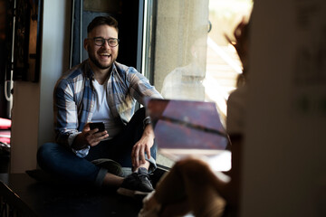 Young businessman using digital tablet in the office. Handsome man learning online.