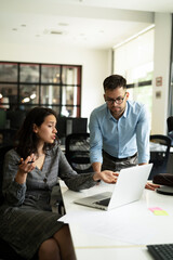 Colleagues in office. Businesswoman and businessman discussing work in office..