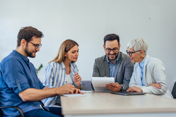 Close up of a people working together, having a meeting, reading some new company rules.