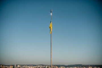 Obraz premium Ukraine flag large national symbol fluttering in blue sky. Large yellow blue Ukrainian state flag, Lviv city, Independence Constitution Day, National holiday.