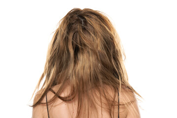 Back view of a young woman with messy long hair on a white background