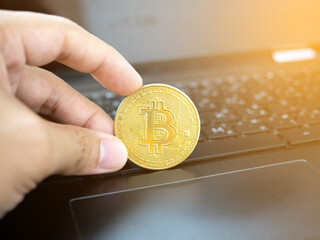 Hand hold bitcoin on keyboard laptop digital money,Crypto money