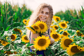Hot summer mood, cute girl in the field of sunflowers, joy and smile to the sun