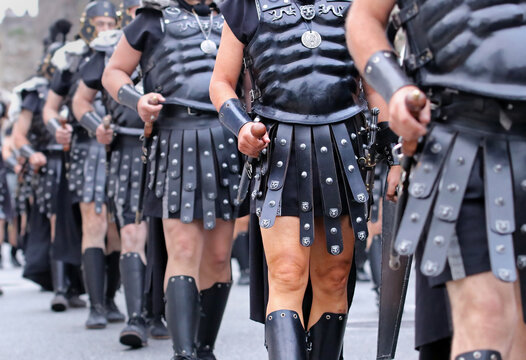 Detail of the armors, swords and shields of white men disguised as roman warriors in the Arde Lucus festival. Legionary roman troops walking and performing a show on the streets of Lugo.