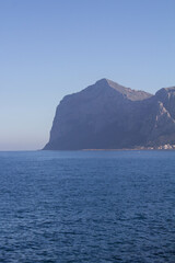 Fototapeta na wymiar evocative image of sea coast with promontory on the background in Sicily, Italy