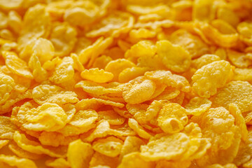 crispy golden cornflakes on a white acrylic background