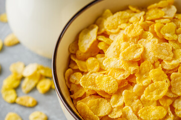 crispy golden cornflakes on a gray concrete background