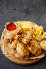 crispy deep-fried chicken drumsticks on a black background