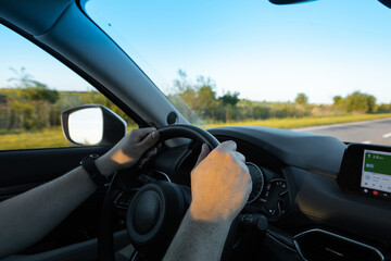 man hands on steering wheel car driving