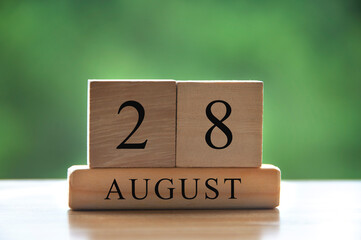 August 28 calendar date text on wooden blocks with blurred background park. Copy space and calendar concept