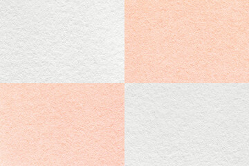 Fototapeta premium Texture of craft white and pearl coral paper background with cells pattern, macro. Structure of vintage pink cardboard.