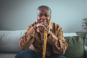 Shot of a senior man looking thoughtfully out of a window at home. Positive African American senior...