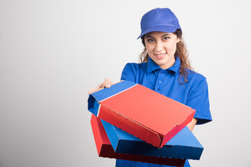 Pizza delivery girl holding three boxes on white background