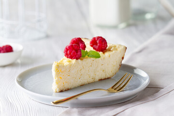 Piece of cheesecake with raspberries