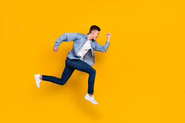 Fototapeta na wymiar Full body profile side photo of young man runner jumper rush discount isolated over yellow color background