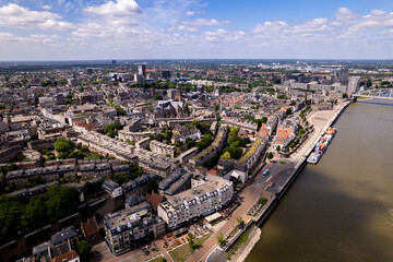 Fototapeta na wymiar Aerial cityscape of Dutch Hanseatic town seen from above along the river Waal on a warm sunny day