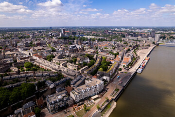 Aerial cityscape of Dutch Hanseatic town seen from above along the river Waal on a warm sunny day