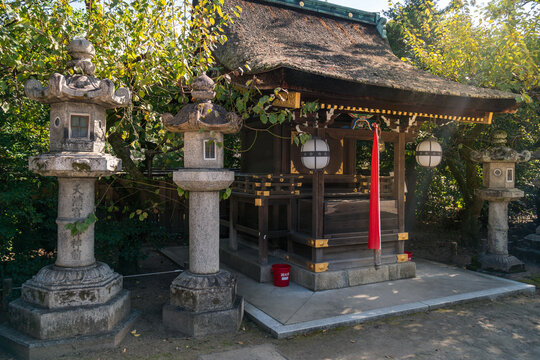 Avenue with stone lanterns at the entrance to Poet's Festival Kitano Tenmangu in Kyoto, Japan.