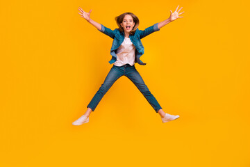 Full body photo of overjoyed satisfied person jumping raise opened arms falling isolated on yellow color background