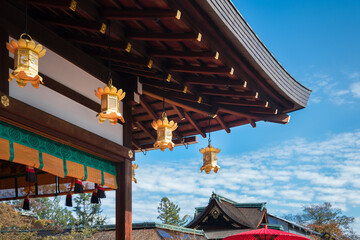 Architectural roof details with golden lanterns at the Poet's Festival, Kitano Tenmangu Sanctuary in Kyoto Japan.