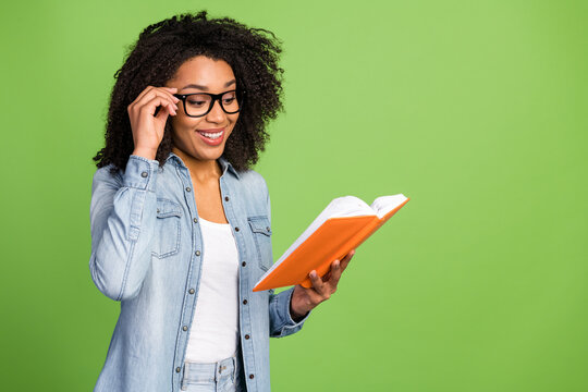 Profile side photo of young pretty woman read book hand touch eyeglasses isolated over green color background