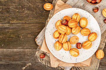Cookies in the shape of walnuts with condensed milk cream filling.Delicious shortbread sandwiches