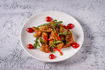 chicken meat and vegetable salad. on a light concrete background