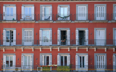 Beautiful view of the famous landmark Plaza Mayor with statue from Madrid, Spain, during a hot summer day with blue sky and the architecture vintage details in frame.