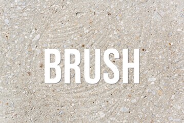 BRUSH - word on concrete background. Cement floor, wall.