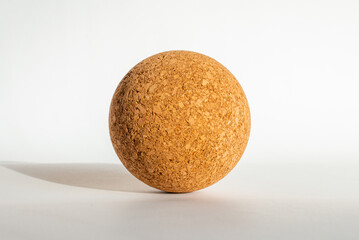 Nice brown cork ball lie on the white gray background,close up.