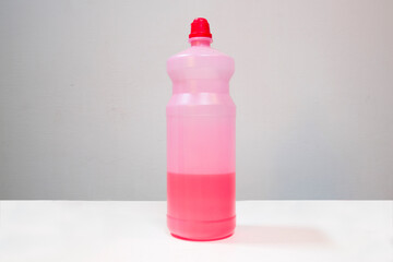 Closeup of a plastic bottle for disinfectant liquid on a white background. House cleaning concept.