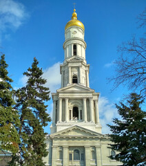 Cathedral in Kharkov. Christian Church. White tall building. Bell tower against the blue sky