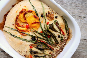 baked focaccia bread with your own hands at home close-up selective focus.