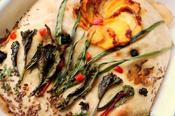 baked focaccia bread with your own hands at home close-up selective focus.