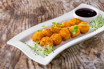 Fish croquettes with currant sauce