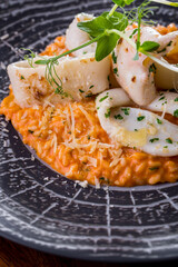 Risotto with tomato paste and squid