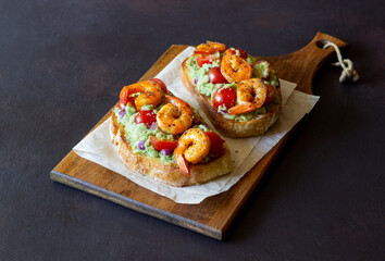 Bruschetta with shrimp, guacamole and tomatoes. Healthy eating. Breakfast.